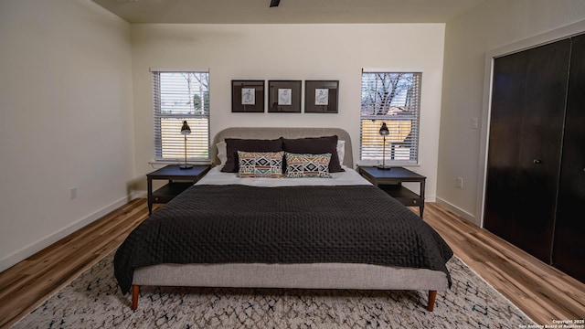 bedroom featuring hardwood / wood-style floors and a closet