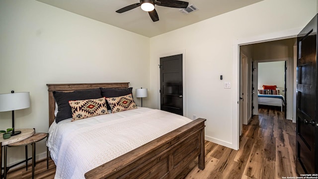 bedroom featuring ceiling fan and dark hardwood / wood-style floors