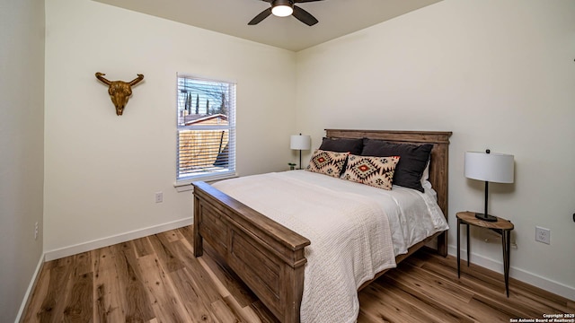 bedroom featuring ceiling fan and light hardwood / wood-style flooring