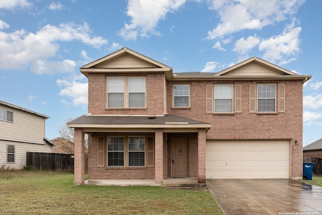 view of front of property featuring a front yard and a garage