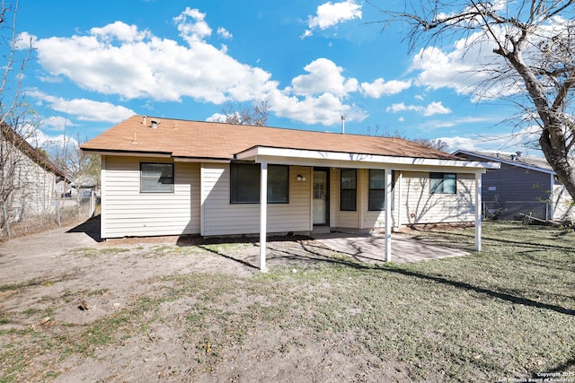 back of property featuring a yard and a patio