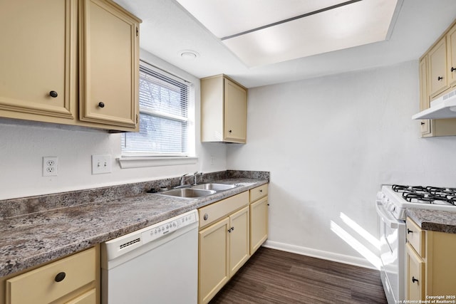 kitchen with white appliances, sink, and dark wood-type flooring