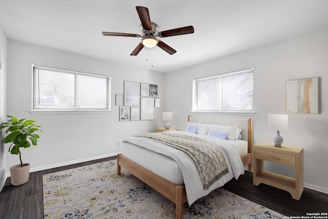 bedroom featuring multiple windows, ceiling fan, and dark wood-type flooring