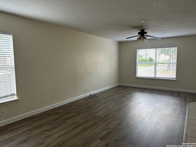 unfurnished room featuring a textured ceiling, ceiling fan, and dark wood-type flooring