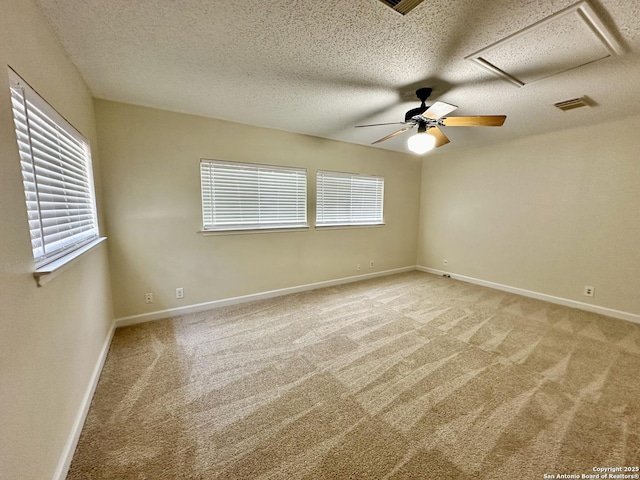 empty room featuring a textured ceiling, carpet floors, and ceiling fan