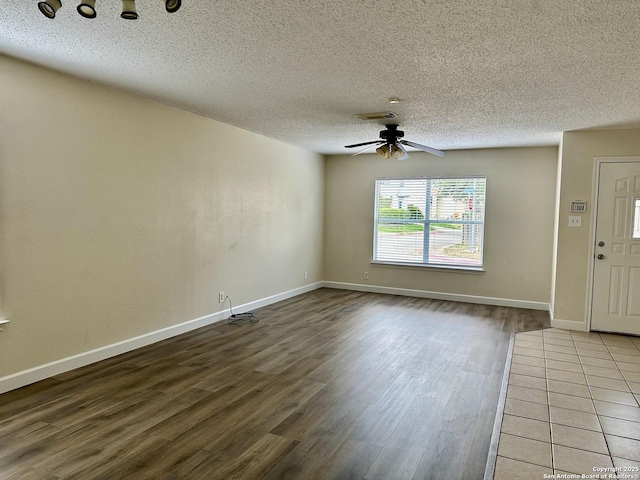 foyer entrance with hardwood / wood-style floors, ceiling fan, and a textured ceiling