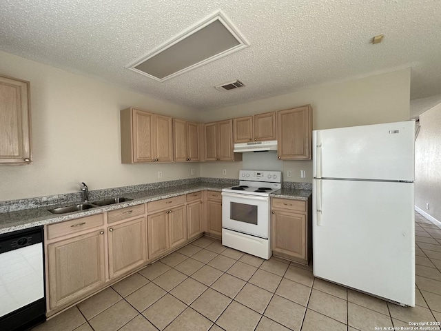 kitchen with white appliances, sink, light tile patterned floors, a textured ceiling, and light brown cabinetry