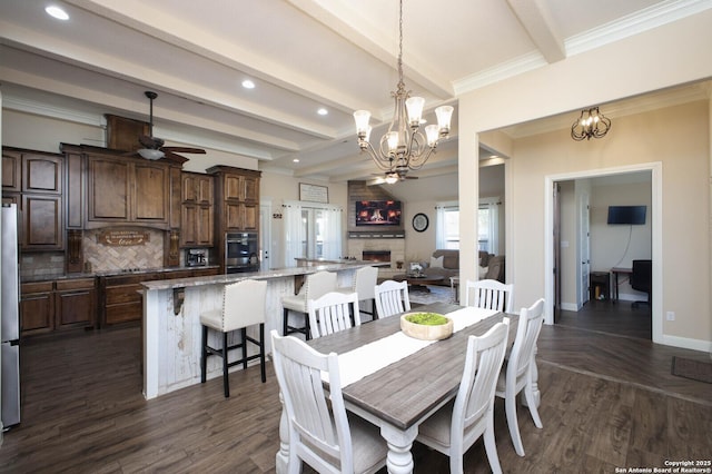 dining area featuring beamed ceiling, dark hardwood / wood-style flooring, and ceiling fan with notable chandelier