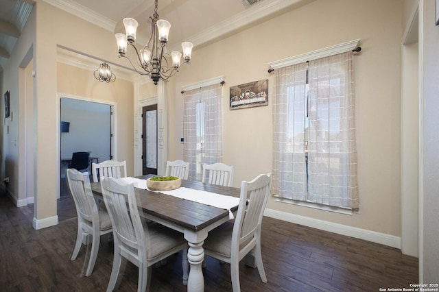 dining space featuring dark hardwood / wood-style flooring, a chandelier, and ornamental molding