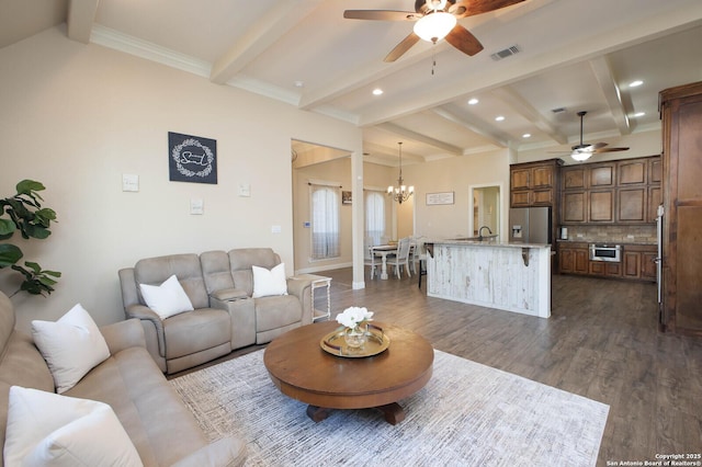 living room featuring ceiling fan with notable chandelier, beam ceiling, and dark wood-type flooring