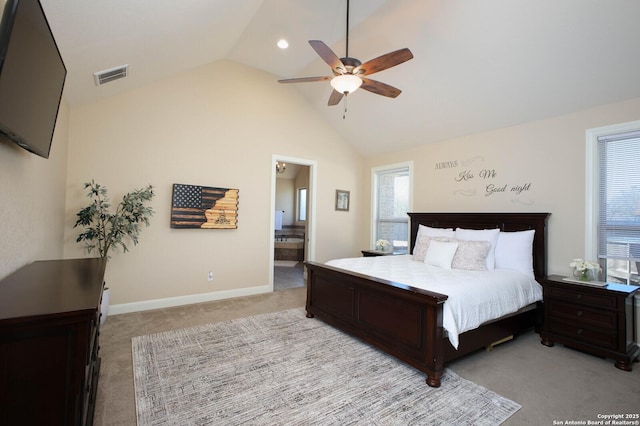 bedroom featuring ensuite bathroom, ceiling fan, light carpet, and lofted ceiling