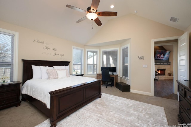 bedroom with multiple windows, ceiling fan, and light carpet