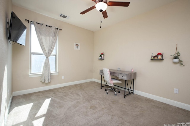 carpeted home office featuring ceiling fan