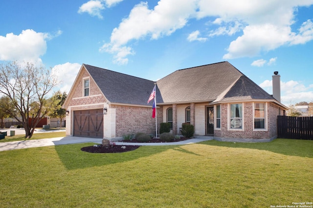 view of front of house with a garage and a front lawn