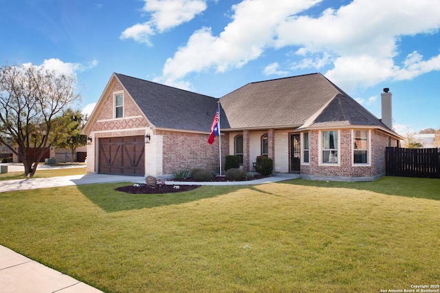 view of front of property with a front yard and a garage