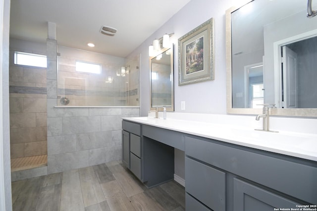 bathroom featuring vanity and tiled shower