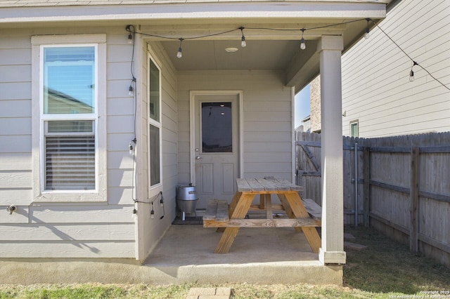 view of exterior entry with a patio