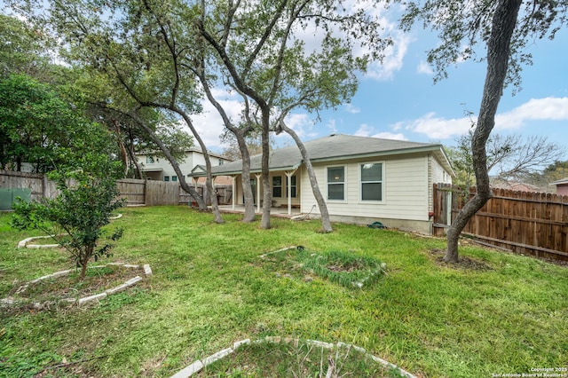 rear view of property with a yard