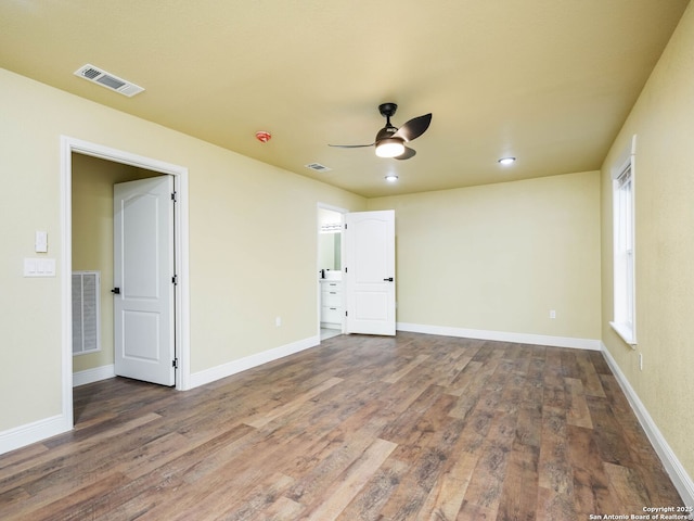 unfurnished room with dark hardwood / wood-style flooring and ceiling fan