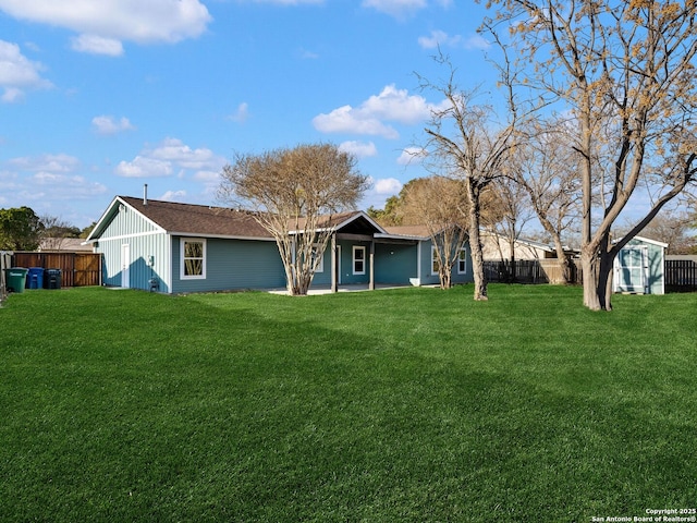 ranch-style home with a front lawn and a storage shed