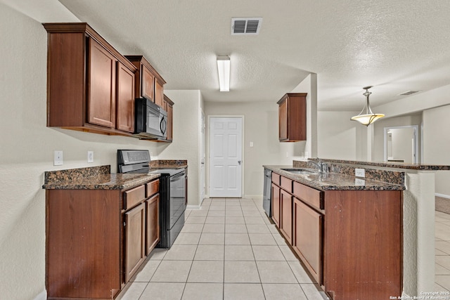 kitchen with light tile patterned floors, decorative light fixtures, dark stone countertops, and black appliances