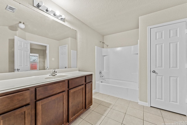 bathroom with vanity, shower / bathing tub combination, a textured ceiling, and tile patterned floors