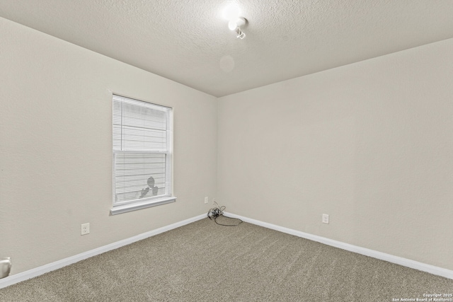 unfurnished room featuring carpet floors and a textured ceiling