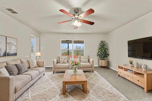 living room with light carpet, a textured ceiling, and ceiling fan