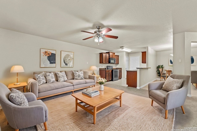 carpeted living room with ceiling fan and a textured ceiling