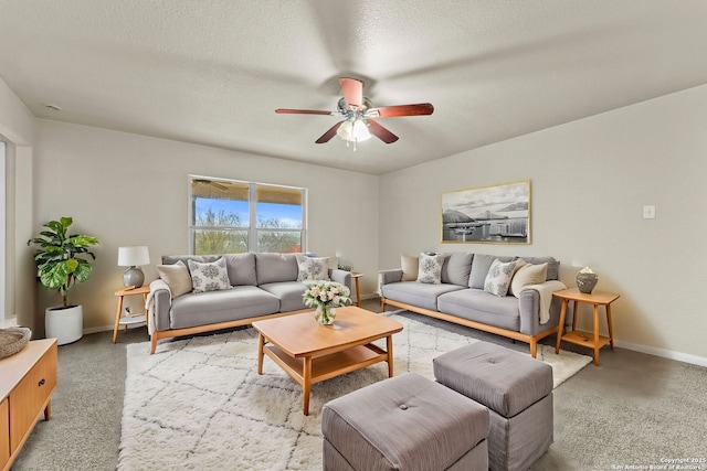 carpeted living room with ceiling fan and a textured ceiling