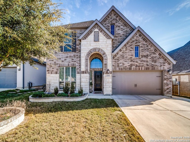 view of front of property with a garage and a front lawn