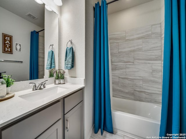 bathroom featuring vanity and shower / bath combo with shower curtain