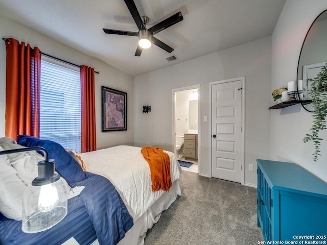 bedroom featuring ceiling fan, ensuite bathroom, and carpet floors