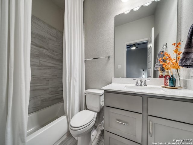 full bathroom featuring toilet, shower / bath combination with curtain, and vanity