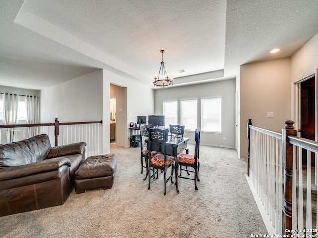 dining space featuring an inviting chandelier, light carpet, and a textured ceiling