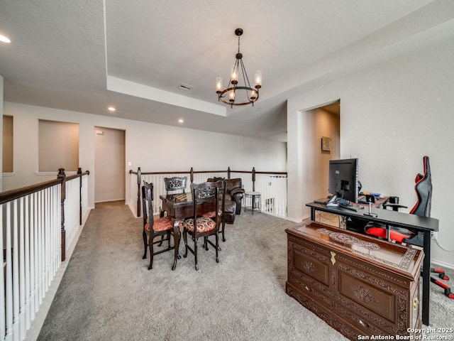 carpeted dining area with a tray ceiling and a chandelier