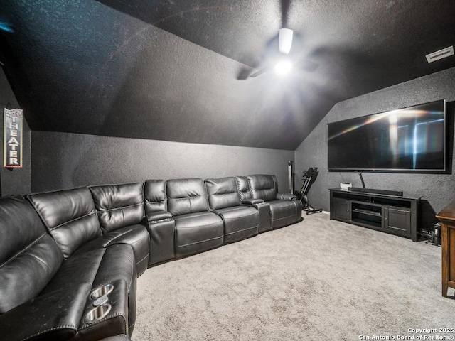 cinema with ceiling fan, carpet, a textured ceiling, and lofted ceiling