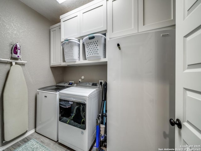 washroom with cabinets and separate washer and dryer