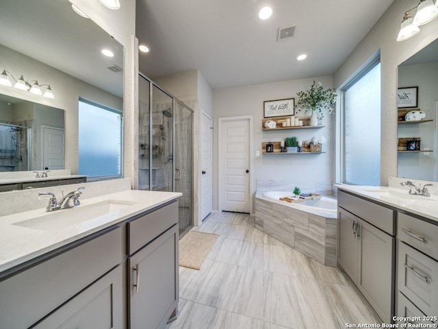 bathroom featuring vanity and separate shower and tub