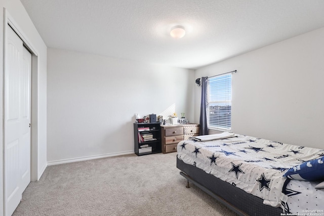 bedroom featuring light carpet and a closet