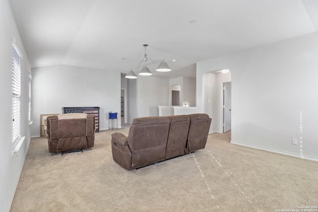 living room featuring lofted ceiling and light carpet