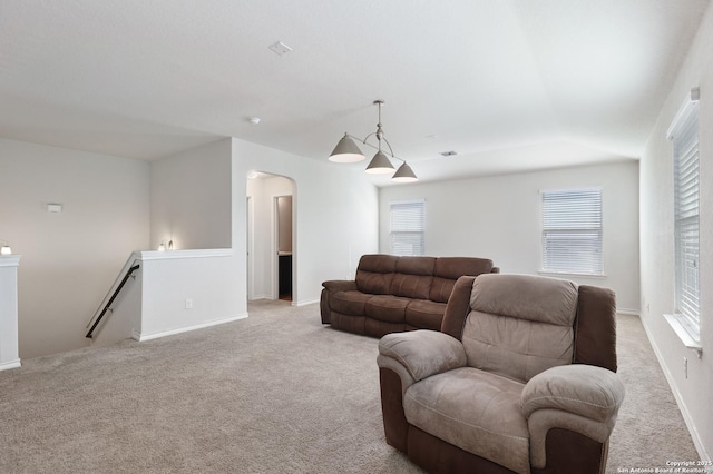 carpeted living room with a healthy amount of sunlight