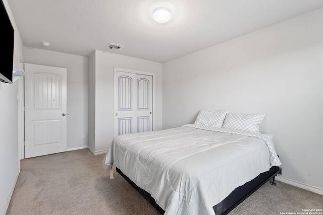 bedroom with light carpet and a closet