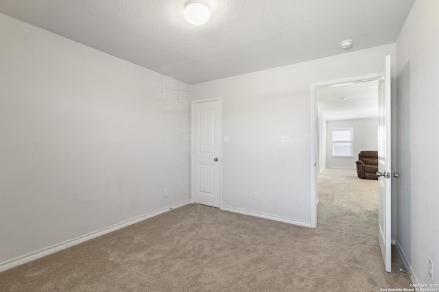 carpeted spare room featuring a textured ceiling