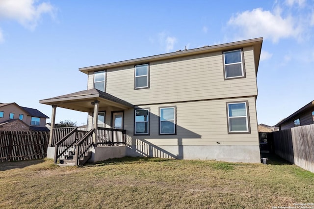 rear view of property with a yard