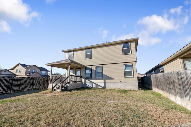 back of house featuring a yard