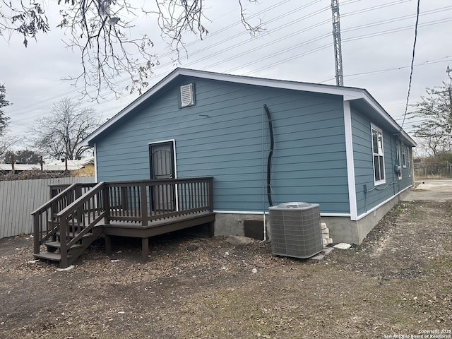 rear view of house featuring a deck and cooling unit