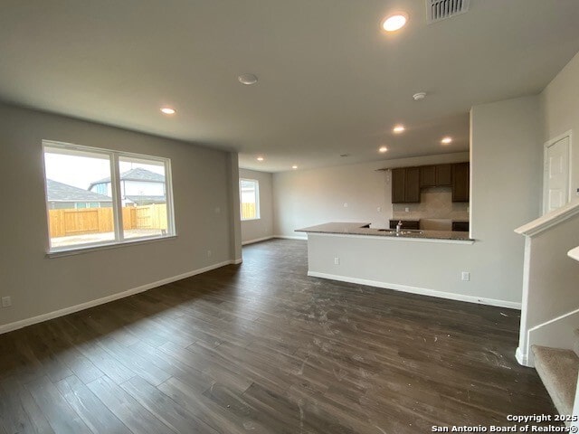 unfurnished living room with dark hardwood / wood-style flooring