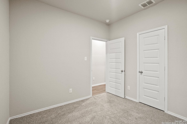 unfurnished bedroom featuring light colored carpet