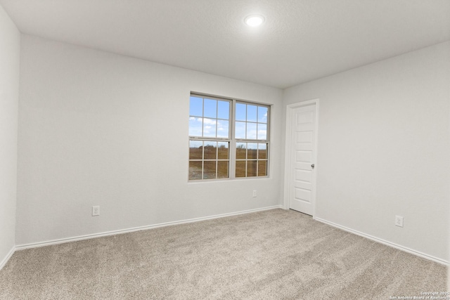 unfurnished room featuring light colored carpet